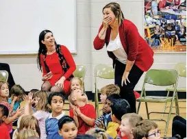  ?? [PHOTO BY CHRIS LANDSBERGE­R, THE OKLAHOMAN] ?? Madison Elementary kindergart­en teacher Hailey Couch, right, reacts after being surprised Tuesday with a Milken Educator Award during an assembly at the school in Norman.