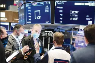  ??  ?? In this file photo provided by the New York Stock Exchange, traders work on the floor, Friday, March 5, 2021, in New York. (AP)