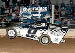  ??  ?? Lovelady’s business partner and friend Greg Keegan, left, driving a modified Lovelady racecar in the 1990s at Woodford Glen Speedway.