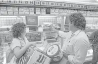  ?? Houston Chronicle file photo ?? Sandie and Steve McGlothlin of La Porte check out the video games at a local Toys “R” Us, looking for sales the Friday after Thanksgivi­ng 1988.