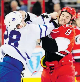  ?? Grant Halverson/afp/getty Images ?? Kevin Westgarth, right, seen fighting Colton Orr of the Toronto Maple Leafs, has been traded to the Flames for first-round draft pick Greg Nemisz.