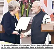  ??  ?? PM Narendra Modi and UK counterpar­t Theresa May shake hands during the joint statement at Hyderabad House in New Delhi on Monday