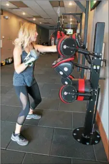  ??  ?? Founder and owner Heather LaFountain using The BoxMaster at Saratoga Bootcamp Bike & Box Studio.