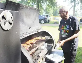  ?? Katie West • Times-Herald ?? Michael Williams, winner of the Forrest City Juneteenth King of the South Cookoff, manages his grill during Saturday’s event. Juneteenth celebratio­ns were held at the Sports Complex throughout the weekend.