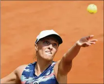  ?? ALESSANDRA TARANTINO/AP ?? Poland’s Iga Swiatek serves to Ons Jabeur during their final match at the Italian Open in Rome on Sunday. Swiatek is an overwhelmi­ng favorite to win her second French Open.