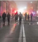  ?? Photo / AP ?? People walk in Kyiv’s city centre which lost power after a Russian rocket attack.