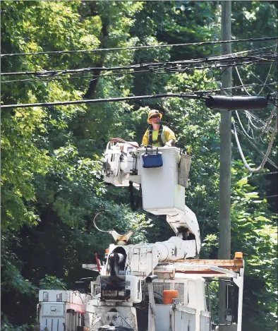  ?? Tyler Sizemore / Hearst Connecticu­t Media ?? Crews repair powerlines on Doubling Road after Tropical Storm Isaias hit Greenwich on August. Many Eversource customers still remain without power as crews continue scrambling to repair downed powerlines and clean up fallen trees.