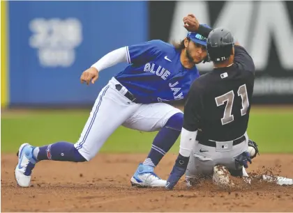  ?? STEVE NESIUS/THE CANADIAN PRESS ?? Shortstop Bo Bichette, left, and the rest of the Toronto Blue Jays will be starting the regular season in Dunedin.