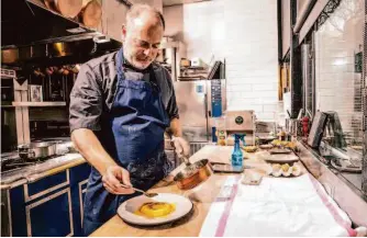  ?? Photos by Stephen Lam/The Chronicle ?? Michael Tusk, chef-owner of Quince and Cotogna, drizzles brown butter onto a raviolo di ricotta during a cooking demonstrat­ion in San Francisco, Calif., Tuesday, Feb. 7, 2023.