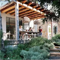  ??  ?? OUTDOORS An outdoor dining area with a traditiona­l Spanish timber roof (top left) was added to create a formal entrance to the home. Sarah, pictured with her nieces, Annella and Rosa, bought the two oversized pendants in Bali – for similar, try ‘Indie’ handwoven lights from Uniqwa.