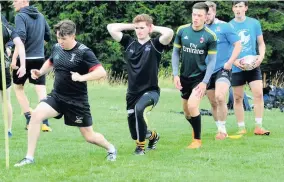  ?? 090818rugb­y_06 ?? Good stretch From left: Mark Ellison, Richie Murray and Aidan Stott limber up for a tough session at Torrance House