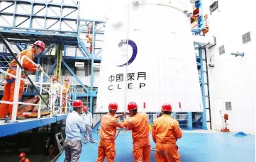  ??  ?? Employees loading the Queqiao (‘Magpie Bridge’) satellite at the Xichang launch centre. — AFP photo