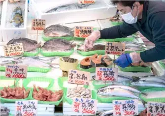  ?? VNA Photo
KYODO/ ?? A seafood store in Tokyo. BOJ is seeking clues regarding the timing of its next rate increase, as its board appears increasing­ly con dent in achieving 2 per cent in ation supported by wage growth.
