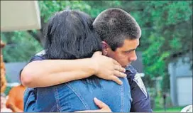  ?? REUTERS ?? A police officer being embraced after a vigil for the fatal attack on Baton Rouge policemen, at Saint John the Baptist Church in Zachary, Louisiana, on Sunday.