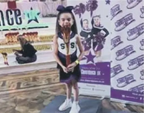  ??  ?? Scarlett with her trophy at the Cheerdance UK competitio­n in Blackpool.