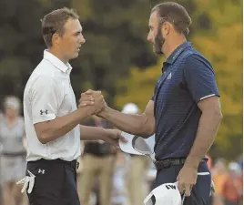  ?? AP PHOTO ?? FINISHING TOUCH: Dustin Johnson (right) shakes hands with Jordan Spieth after winning the Northern Trust Open in Old Westbury, N.Y.