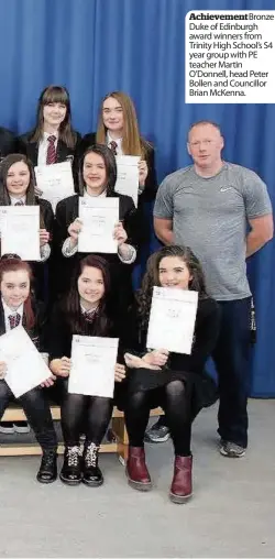  ??  ?? Achievemen­t Bronze Duke of Edinburgh award winners from Trinity High School’s S4 year group with PE teacher Martin O’Donnell, head Peter Bollen and Councillor Brian McKenna.