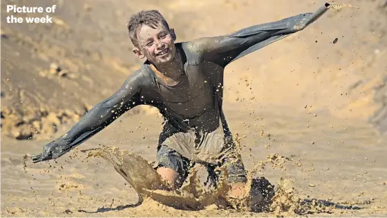  ?? Picture / Brett Phibbs ?? It was all about having a go during the Mud Monster Mud Rush at Massey University's Albany campus on Sunday.