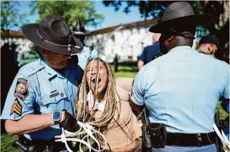  ?? Mike Stewart/associated Press ?? Georgia State Patrol officers detain a demonstrat­or Thursday during a pro-palestinia­n rally on the campus of Emory University in Atlanta.