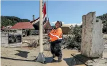  ?? ?? Volunteers clean the urupa at Tangoio Marae, north of Napier. Above: Hoani Taurima raises the Tino Rangatirat­anga flag.
Below: Hori Reti is confident the marae taonga can be salvaged.
