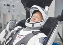  ?? (NASA/Reuters) ?? NASA ASTRONAUT Douglas Hurley rehearses putting on his SpaceX spacesuit earlier this week at the Kennedy Space Center in Cape Canaveral, Florida.