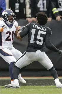  ?? BEN MARGOT, THE ASSOCIATED PRESS ?? Denver Broncos Aqib Talib fights Oakland Raiders Michael Crabtree during a brawl that erupted in the first half of Sunday’s NFL game.