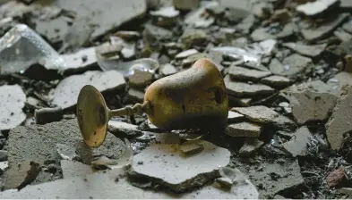  ?? ARIEL SCHALIT/AP ?? A burnt Kiddush cup lies among other debris Oct. 13 in a house damaged during Hamas’ attack on Kibbutz Be’eri, Israel.