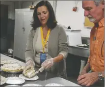  ?? The Sentinel-Record/Grace Brown ?? PIE BREAK: Ninette Sosa, left, plates up a piece of pie donated to the Hot Springs Documentar­y Film Festival by PattiCakes of Conway as Rick Talley prepares to place the plate on a cart at the Arlington Resort Hotel &amp; Spa on Tuesday. The pie followed a screening of “Make Room For Pie,” about the best homemade pies in kitchens, cafes and bakeries in Arkansas.