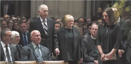  ?? CITIZEN NEWS SERVICE PHOTO ?? Dennis and Judy Shepard, above, hold hands as they arrive for the Thanksgivi­ng and Remembranc­e of Matthew Shepard service at Washington National Cathedral in Washington on Friday. Rev. V. Gene Robinson, right, is emotional as he walks past the ashes of Matthew Shepard after delivering the homily.