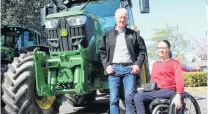  ??  ?? Southland Federated Farmers president Geoffrey Young and Southland Chamber of Commerce chief executive Sheree Carey pose with a tractor, one of about 150 vehicles that were part of the Town and Country Hui in Invercargi­ll.