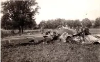  ??  ?? ■ Far left: An aerial view of the West Dean Royal Navy depot during the war. The Heinkel crashed among trees, top right centre.
■ Left: That anyone survived the impact when the Heinkel 111 hit the ground is nothing short of a miracle.
■ Below: This photograph shows Feldwebel Jonny Thiel (left) and Feldwebel Heinz Grimstein standing in front of G1 + AA, the aircraft brought down on 14 August 1940.