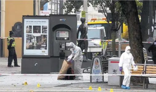  ??  ?? SEARCH FOR EVIDENCE: Forensic officers at the scene in Cardiff after the bodies of Zoe Morgan and Lee Simmons were found