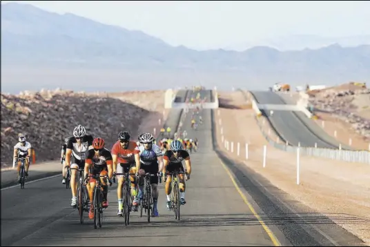  ?? K.M. Cannon Las Vegas Review-Journal @KMCannonPh­oto ?? Cyclists ride on the yet-to-be-opened Interstate 11 on Saturday in Boulder City. The event, sponsored by the Southern Nevada Bicycle Coalition, gave people a chance to ride on the freeway before it opens to motorists on Aug. 9.