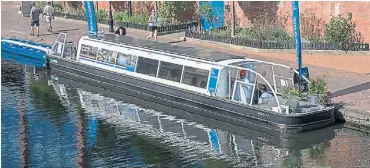  ?? ?? Pennine Princess being used as a floating exhibition and interview location in Birmingham city centre during the games.