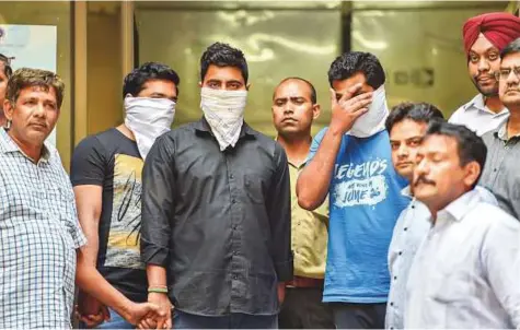  ?? PTI ?? ■ Police parade a coaching centre owner and two teachers who were arrested on suspicion of involvemen­t in circulatin­g the leaked CBSE question papers on social media groups, in New Delhi yesterday.