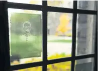  ?? RICHARD LAUTENS TORONTO STAR ?? Portraits of soldiers and nurses from Trinity College — discovered in the archives last year — are displayed on windows overlookin­g the college quad. At left, William George Henry Bates, a Trinity alumnus who died in 1915.