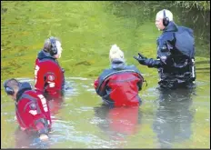  ?? ALEX KORMANN/STAR TRIBUNE VIA AP ?? Water Recovery authoritie­s comb the Apple River with metal detectors, Saturday, after five people were stabbed while tubing down the river in Somerset, Wis.