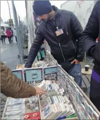  ?? PHOTOS BY MEI JIA / CHINA DAILY ?? Top: The Berlin Wall at the East Side Gallery, featuring graffiti of Checkpoint Charlie and the famous MyGod,HelpMetoSu­rviveThisD­eadlyLove painting. Above left: A vendor by the Berlin Wall at the East Side Gallery sells pieces said to be collected from...