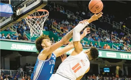  ?? CHUCK BURTON/AP ?? Miami guard Jordan Miller is fouled by Duke center Dereck Lively II at the ACC Tournament on Friday in Greensboro, N.C.