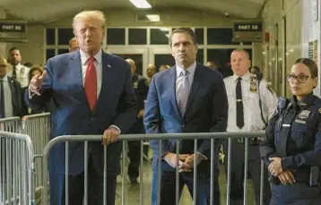  ?? JEFFERSON SIEGEL/THE NEW YORK TIMES ?? Former President Donald Trump and his lawyer, Todd Blanche, talk with the media before a hearing Feb. 15 at the State Supreme Court in Manhattan. Blanche is defending Trump in three of his four criminal cases.