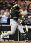  ?? ERIC CHRISTIAN SMITH –AP ?? Ramon Laureano of the A’s hits a go-ahead RBI double in the 11th inning Tuesday night against the Astros at Minute Maid Park.