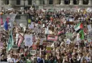  ?? THE ASSOCIATED PRESS ?? Protesters holding banners gather after a march opposed to the visit of U.S. President Donald Trump in Trafalgar Square in London on Friday.