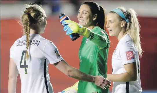  ?? ADRIAN WYLD/THE CANADIAN PRESS ?? U.S. keeper Hope Solo, centre, celebrates with teammates Becky Sauerbrunn, left, and Julie Johnston after defeating China.