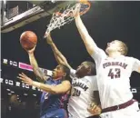  ?? ASSOCIATED PRESS FILE PHOTO ?? Richmond guard Khwan Fore, left, goes to the basket past Fordham forward Ryan Rhoomes (30) and forward Christian Sengfelder (43) during a 2016 game in the Atlantic 10 men’s tournament.