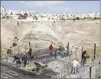  ?? MENAHEM KAHANA/AFP ?? Palestinia­n labourers work at a constructi­on site in a new housing project in the Israeli settlement of Maale Adumim, east of Jerusalem, yesterday.