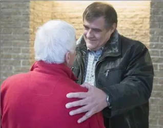  ?? RYAN REMIORZ, THE CANADIAN PRESS ?? Rail traffic controller Richard Labrie hugs Jean Clusiault, left, father of Lac-Mégantic victim Kathy Clusiault, after being found not guilty on the ninth day of deliberati­ons Friday in Sherbrooke, Que.