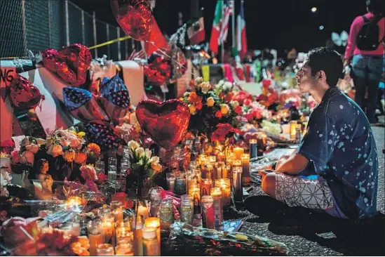  ?? Photograph­s by Paul Ratje AFP/Getty Images ?? RESIDENT Abel Valenzuela meditates Thursday at the makeshift memorial for victims of the Aug. 3 mass shooting. Some worry they might be attacked if they visit.