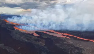  ?? ?? In this aerial photo released by the U.S. Geological Survey, the Mauna Loa volcano is seen erupting from vents on the Northeast Rift Zone on the Big Island of Hawaii, Monday.