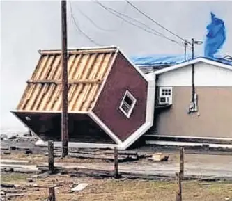  ?? CONTRIBUTE­D ?? High winds uprooted a shed in Lark Harbour on Monday which then came to rest on the side of Myrtles on the Bay. Restaurant owner Victoria Snow figures if it had picked up any more momentum it would have gone right through the building.