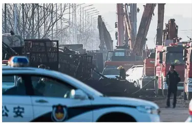  ??  ?? Tragic incident: Policemen and firemen working on the area after an explosion near a chemical factory in Zhangjiako­u. — AFP